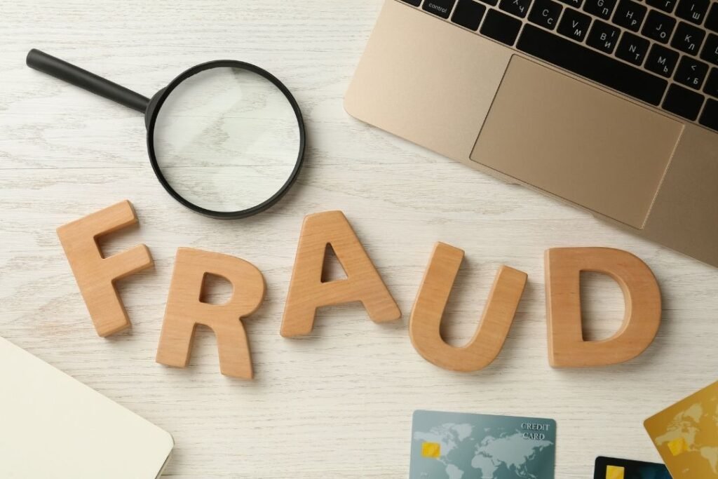 image with laptop and letters that spell fraud