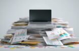 Laptop on a stack of files
