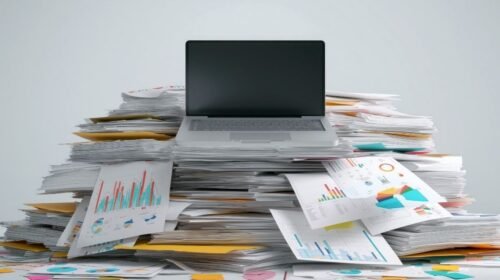 Laptop on a stack of files