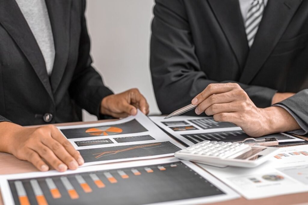 people in suits looking at graphs