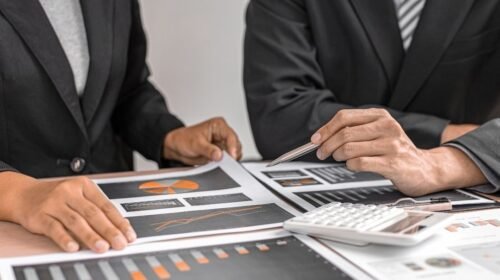 people in suits looking at graphs